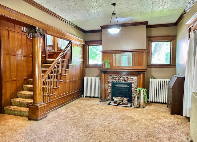 573 Rowland St, Tracy, MN 56175 - unfurnished living room with radiator heating unit, carpet, stairs, and a fireplace with flush hearth