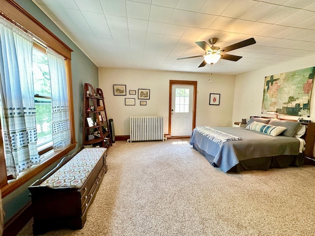 573 Rowland St, Tracy, MN 56175 - carpeted bedroom with radiator and a ceiling fan