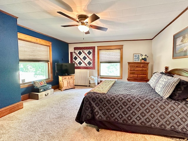 573 Rowland St, Tracy, MN 56175 - carpeted bedroom with radiator, ornamental molding, multiple windows, a ceiling fan, and baseboards