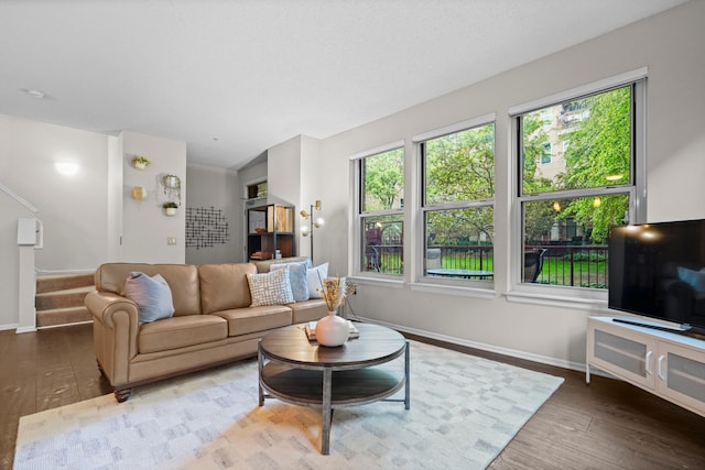 500 2nd St Unit 116, Minneapolis, MN 55401 - living room with wood finished floors, baseboards, and stairway