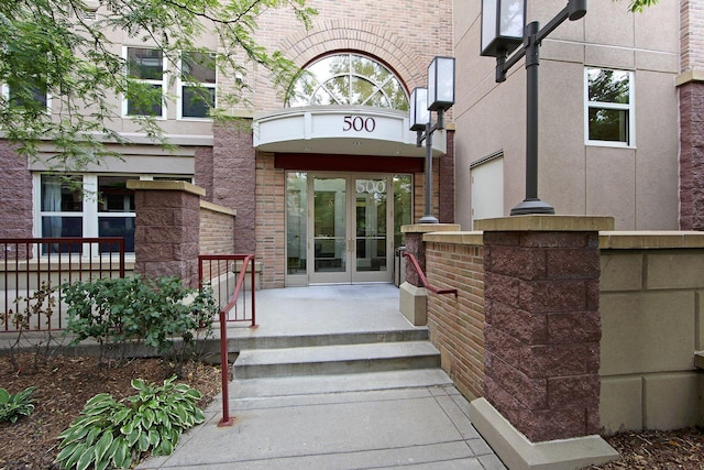 500 2nd St Unit 116, Minneapolis, MN 55401 - view of exterior entry with french doors, brick siding, and stucco siding