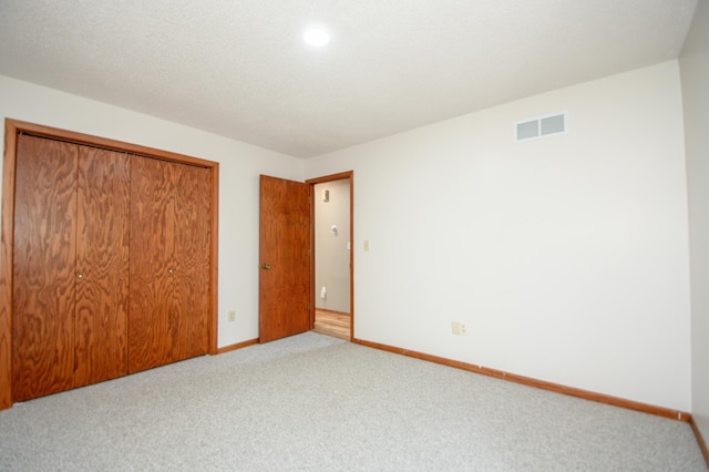 19715 Tyler St NW, Elk River, MN 55330 - unfurnished bedroom with a closet, light carpet, baseboards, and recessed lighting