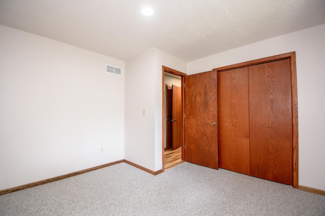19715 Tyler St NW, Elk River, MN 55330 - unfurnished bedroom with a closet, carpet floors, baseboards, and recessed lighting
