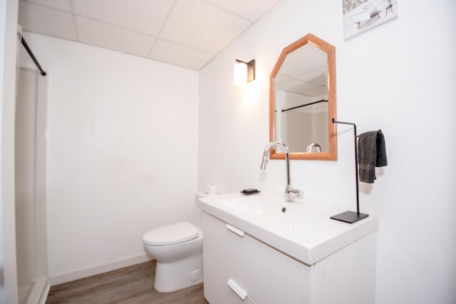 19715 Tyler St NW, Elk River, MN 55330 - bathroom featuring a paneled ceiling, vanity, wood finished floors, toilet, and a shower