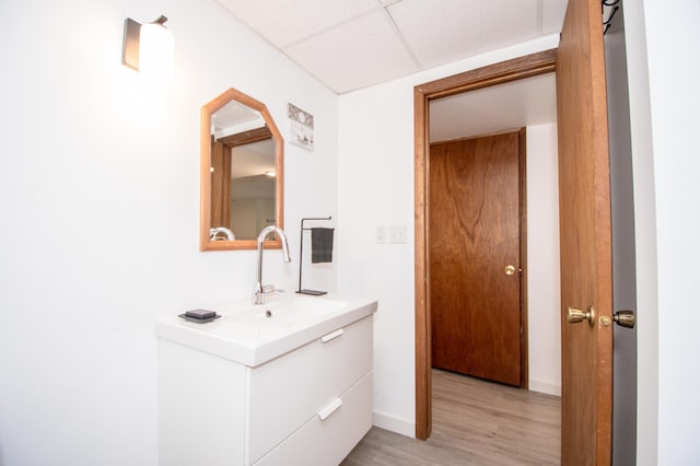 19715 Tyler St NW, Elk River, MN 55330 - bathroom featuring wood finished floors, baseboards, vanity, and a paneled ceiling