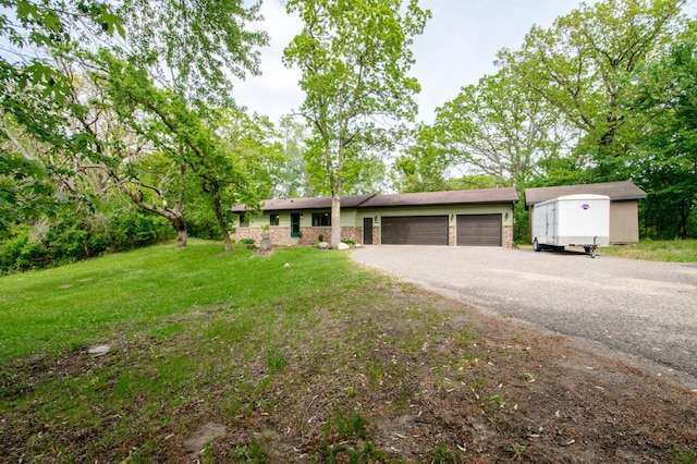 19715 Tyler St NW, Elk River, MN 55330 - ranch-style home featuring a garage, asphalt driveway, and a front yard