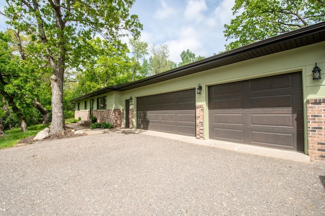 19715 Tyler St NW, Elk River, MN 55330 - view of front of property with brick siding, asphalt driveway, and an attached garage