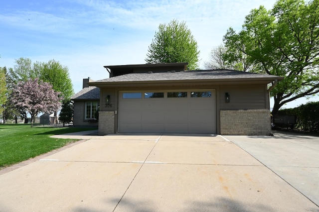 306 Windcrest Ln SE, New Prague, MN 56071 - view of side of property with brick siding, driveway, a garage, and a lawn