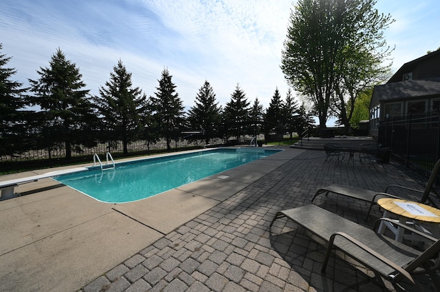 306 Windcrest Ln SE, New Prague, MN 56071 - view of swimming pool with a diving board, a patio area, and fence
