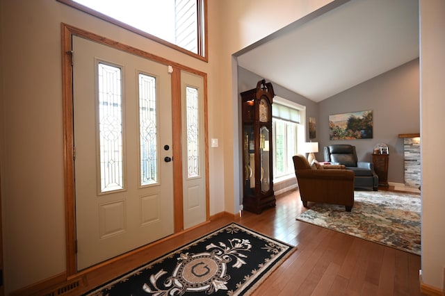 306 Windcrest Ln SE, New Prague, MN 56071 - entrance foyer featuring wood-type flooring, high vaulted ceiling, and baseboards