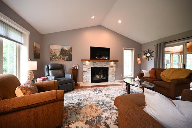 306 Windcrest Ln SE, New Prague, MN 56071 - living area featuring lofted ceiling, a stone fireplace, recessed lighting, and wood finished floors