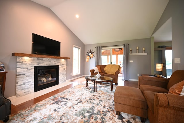 306 Windcrest Ln SE, New Prague, MN 56071 - living area with wood finished floors, a stone fireplace, high vaulted ceiling, recessed lighting, and baseboards