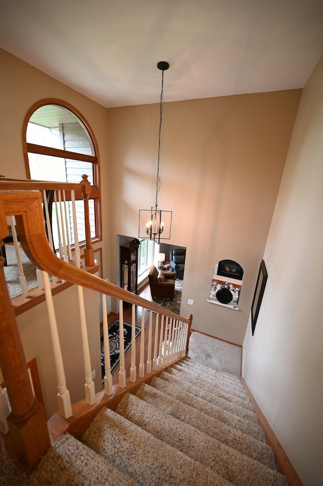 306 Windcrest Ln SE, New Prague, MN 56071 - staircase featuring a chandelier
