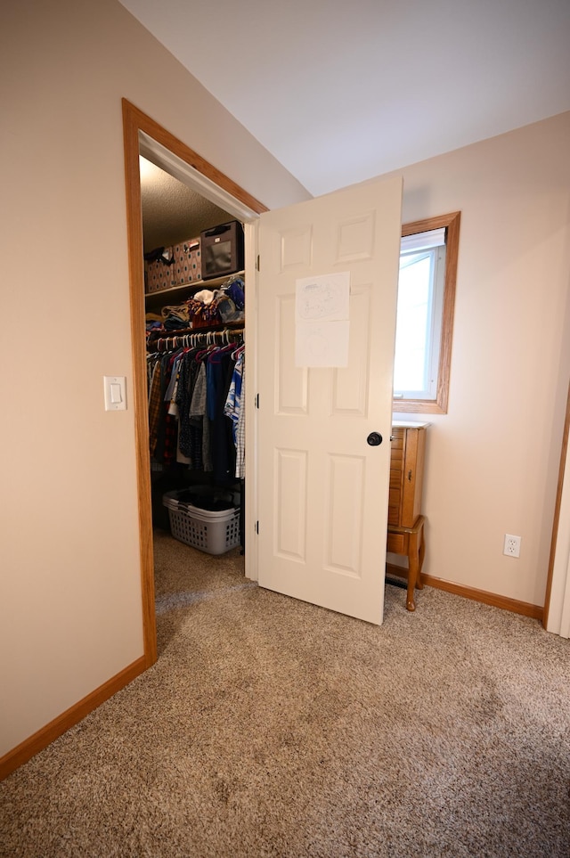 306 Windcrest Ln SE, New Prague, MN 56071 - unfurnished bedroom featuring carpet, baseboards, a closet, and a walk in closet