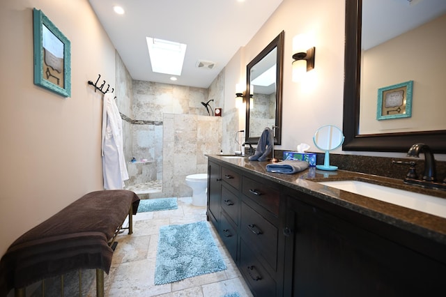 306 Windcrest Ln SE, New Prague, MN 56071 - full bathroom featuring a skylight, toilet, walk in shower, double vanity, and stone tile floors