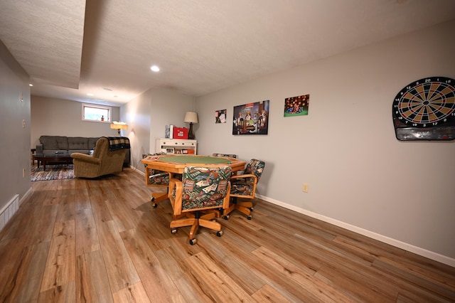 306 Windcrest Ln SE, New Prague, MN 56071 - dining area with wood finished floors, recessed lighting, baseboards, and a textured ceiling