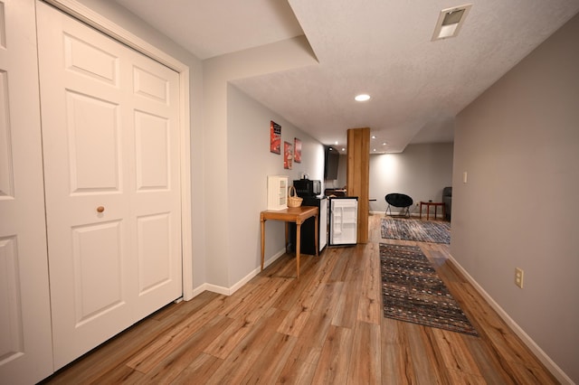 306 Windcrest Ln SE, New Prague, MN 56071 - hallway with light wood-style flooring, baseboards, recessed lighting, and wine cooler