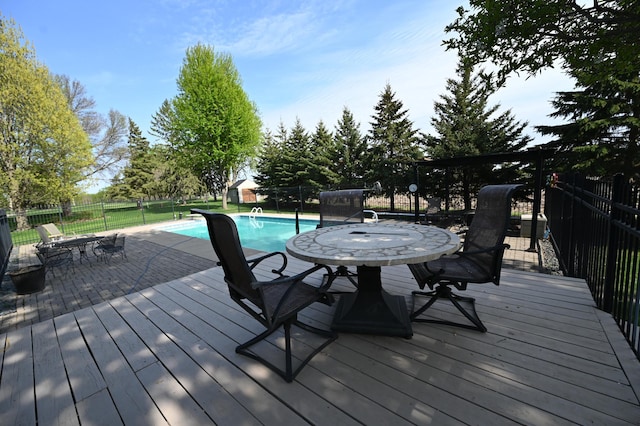 306 Windcrest Ln SE, New Prague, MN 56071 - wooden deck featuring a fenced backyard and outdoor dining space