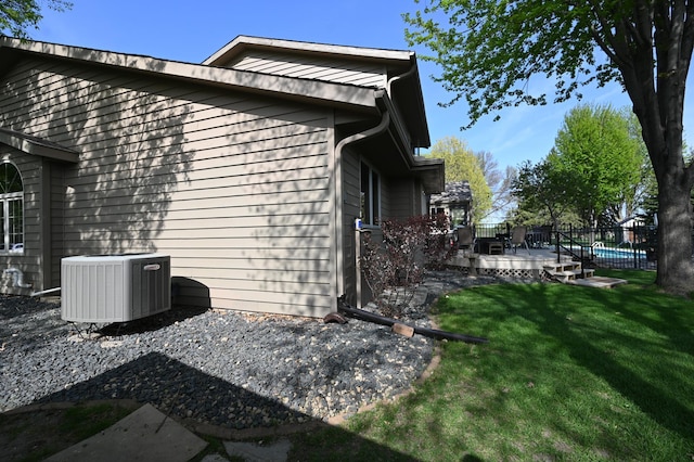 306 Windcrest Ln SE, New Prague, MN 56071 - view of property exterior with cooling unit, a lawn, and a deck