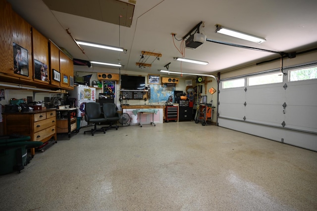 306 Windcrest Ln SE, New Prague, MN 56071 - garage featuring a garage door opener and a workshop area
