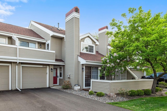 1925 Shenandoah Ct Unit F, Plymouth, MN 55447 - multi unit property featuring a chimney, roof with shingles, and driveway
