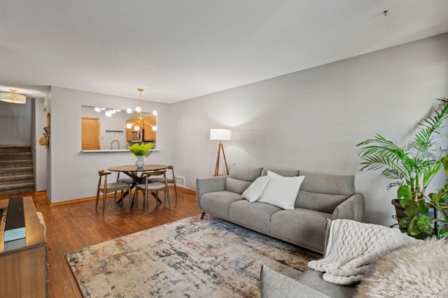 1925 Shenandoah Ct Unit F, Plymouth, MN 55447 - living area featuring stairs, a chandelier, wood finished floors, baseboards, and a textured ceiling