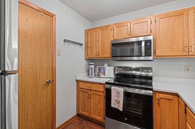 1925 Shenandoah Ct Unit F, Plymouth, MN 55447 - kitchen with appliances with stainless steel finishes, light countertops, dark wood-style flooring, and a textured ceiling