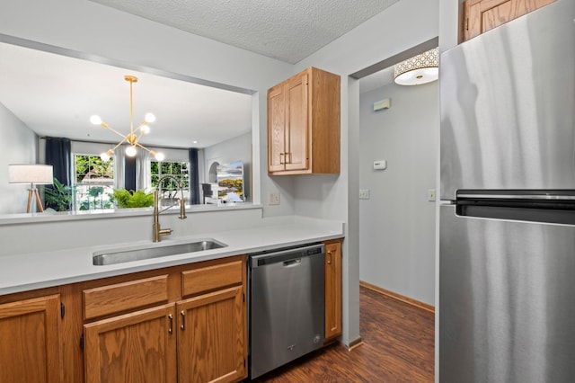 1925 Shenandoah Ct Unit F, Plymouth, MN 55447 - kitchen with stainless steel appliances, a sink, dark wood finished floors, light countertops, and a chandelier