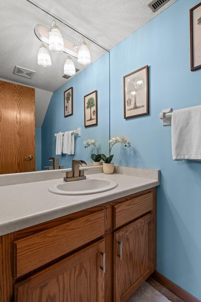 1925 Shenandoah Ct Unit F, Plymouth, MN 55447 - bathroom featuring a textured ceiling, vanity, and vaulted ceiling