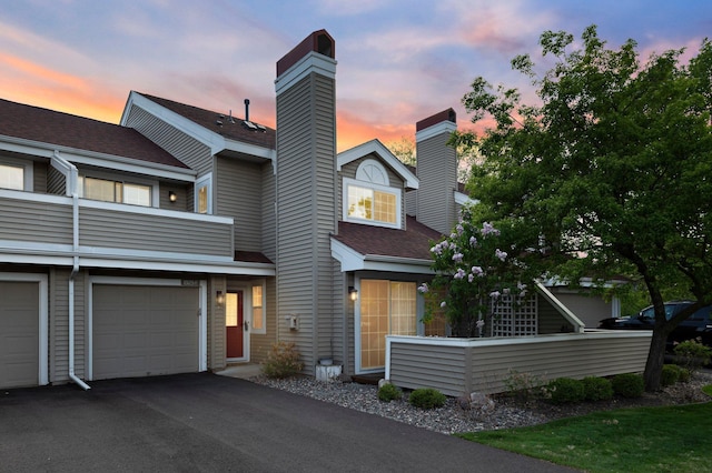1925 Shenandoah Ct Unit F, Plymouth, MN 55447 - view of front of house with a chimney, roof with shingles, an attached garage, and driveway
