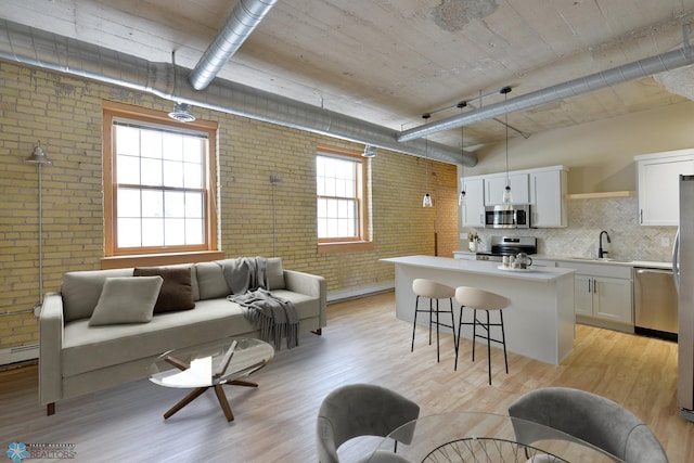 210 11th St N Unit 202, Fargo, ND 58102 - living area featuring brick wall and light wood finished floors