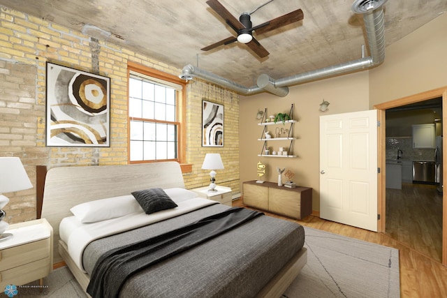 210 11th St N Unit 202, Fargo, ND 58102 - bedroom featuring brick wall and wood finished floors