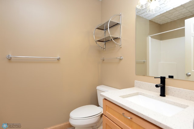 210 11th St N Unit 202, Fargo, ND 58102 - bathroom featuring toilet, vanity, and baseboards