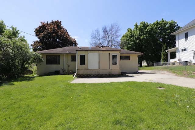 718 1st St SW, Faribault, MN 55021 - back of house with stucco siding and a patio area