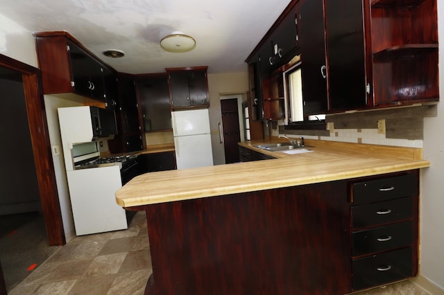 718 1st St SW, Faribault, MN 55021 - kitchen with a sink, a peninsula, freestanding refrigerator, range with gas stovetop, and open shelves