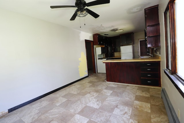 718 1st St SW, Faribault, MN 55021 - kitchen with baseboard heating, freestanding refrigerator, a peninsula, light countertops, and ceiling fan