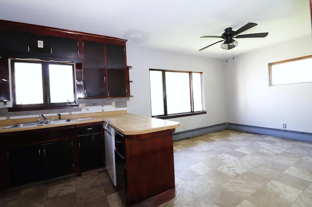 718 1st St SW, Faribault, MN 55021 - kitchen with a peninsula, light countertops, dishwasher, backsplash, and ceiling fan