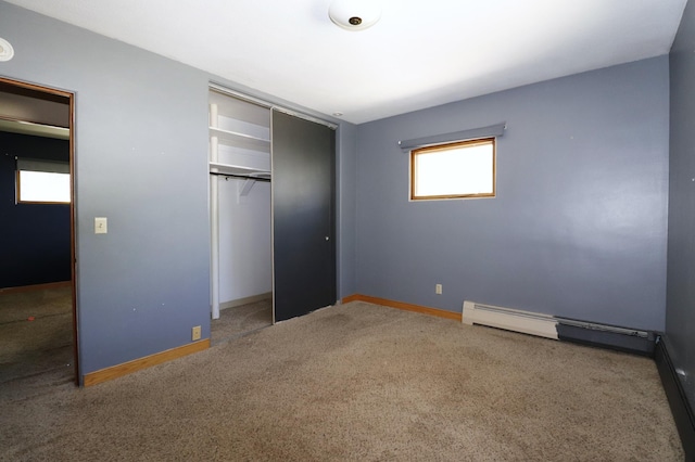 718 1st St SW, Faribault, MN 55021 - unfurnished bedroom featuring carpet flooring, baseboards, a closet, and baseboard heating