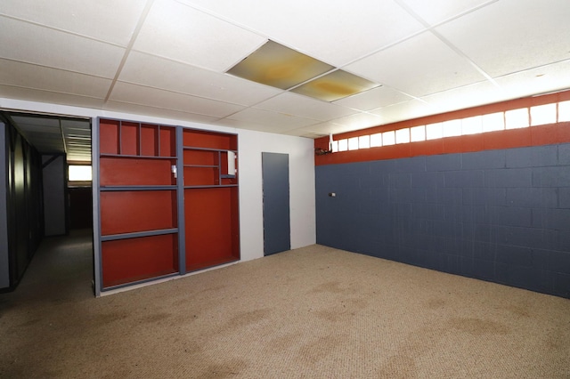 718 1st St SW, Faribault, MN 55021 - basement featuring concrete block wall, carpet floors, and a drop ceiling