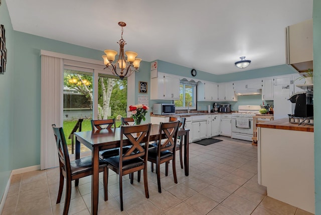 830 Halliday Rd, Saint Cloud, MN 56301 - dining space featuring a chandelier, light tile patterned floors, and baseboards