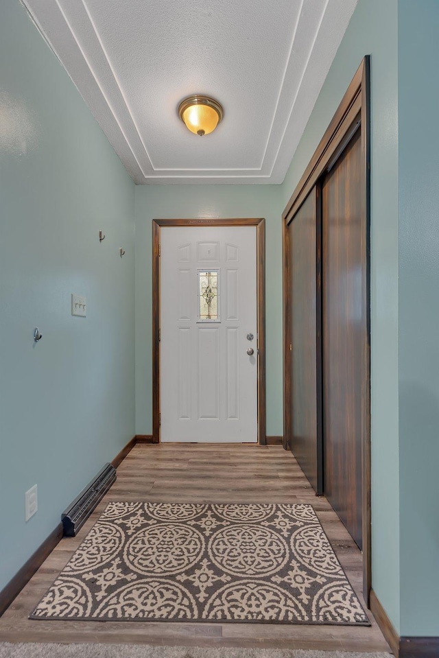 830 Halliday Rd, Saint Cloud, MN 56301 - doorway to outside featuring light wood-type flooring, baseboards, and a textured ceiling