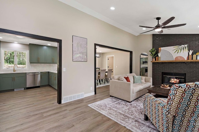 77 Emerson Ave W, West Saint Paul, MN 55118 - living area with light wood-type flooring, a ceiling fan, a fireplace, a high ceiling, and recessed lighting