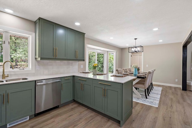 77 Emerson Ave W, West Saint Paul, MN 55118 - kitchen featuring stainless steel dishwasher, a sink, green cabinets, a peninsula, and a textured ceiling