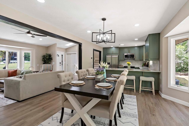 77 Emerson Ave W, West Saint Paul, MN 55118 - dining room featuring light wood-style flooring, a chandelier, baseboards, recessed lighting, and ceiling fan