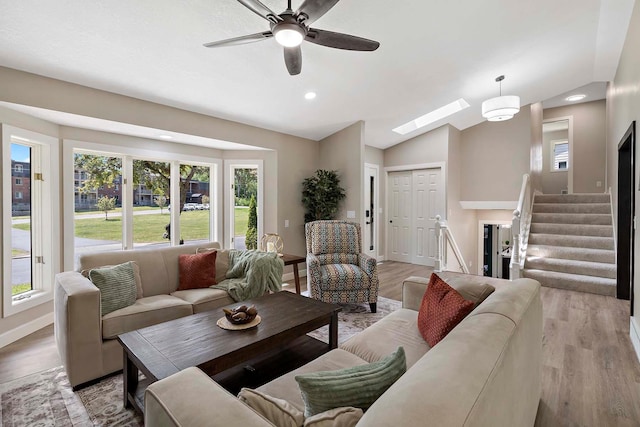 77 Emerson Ave W, West Saint Paul, MN 55118 - living room with wood finished floors, stairs, a skylight, lofted ceiling, and recessed lighting