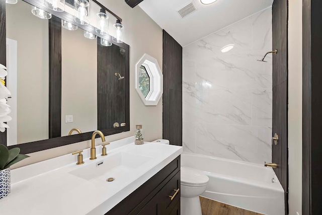 77 Emerson Ave W, West Saint Paul, MN 55118 - bathroom with toilet, shower / washtub combination, wood finished floors, and vanity