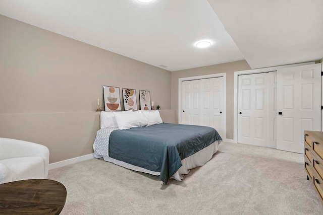 77 Emerson Ave W, West Saint Paul, MN 55118 - bedroom with multiple closets, light carpet, and baseboards