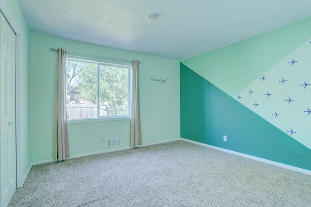 2714 18th Ave S, Minneapolis, MN 55407 - bonus room with carpet, baseboards, and a textured ceiling