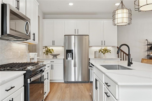 10391 Glacier Ln N, Maple Grove, MN 55369 - kitchen featuring stainless steel appliances, a sink, recessed lighting, backsplash, and white cabinets