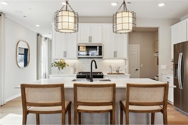 10391 Glacier Ln N, Maple Grove, MN 55369 - kitchen featuring appliances with stainless steel finishes, decorative backsplash, light countertops, white cabinetry, and recessed lighting